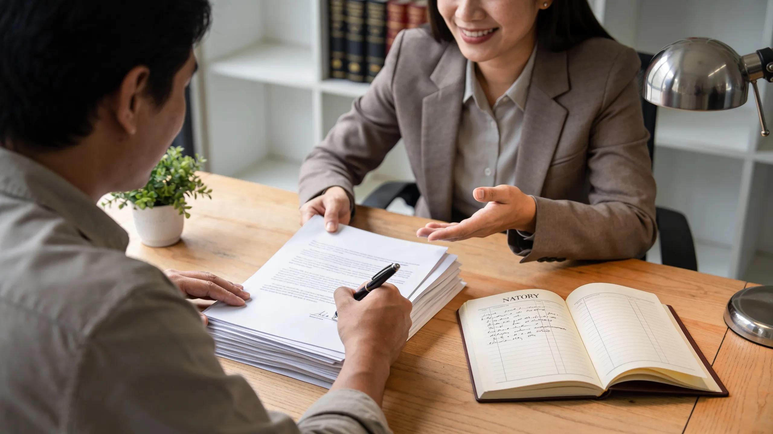 Client engagement during a notary appointment, highlighting the signing process in a professional setting